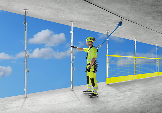 Installing compression posts and barriers as fall protection at construction site