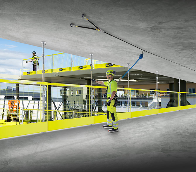Installing compression posts and barriers as fall protection at construction site using scissorsafe anchor system